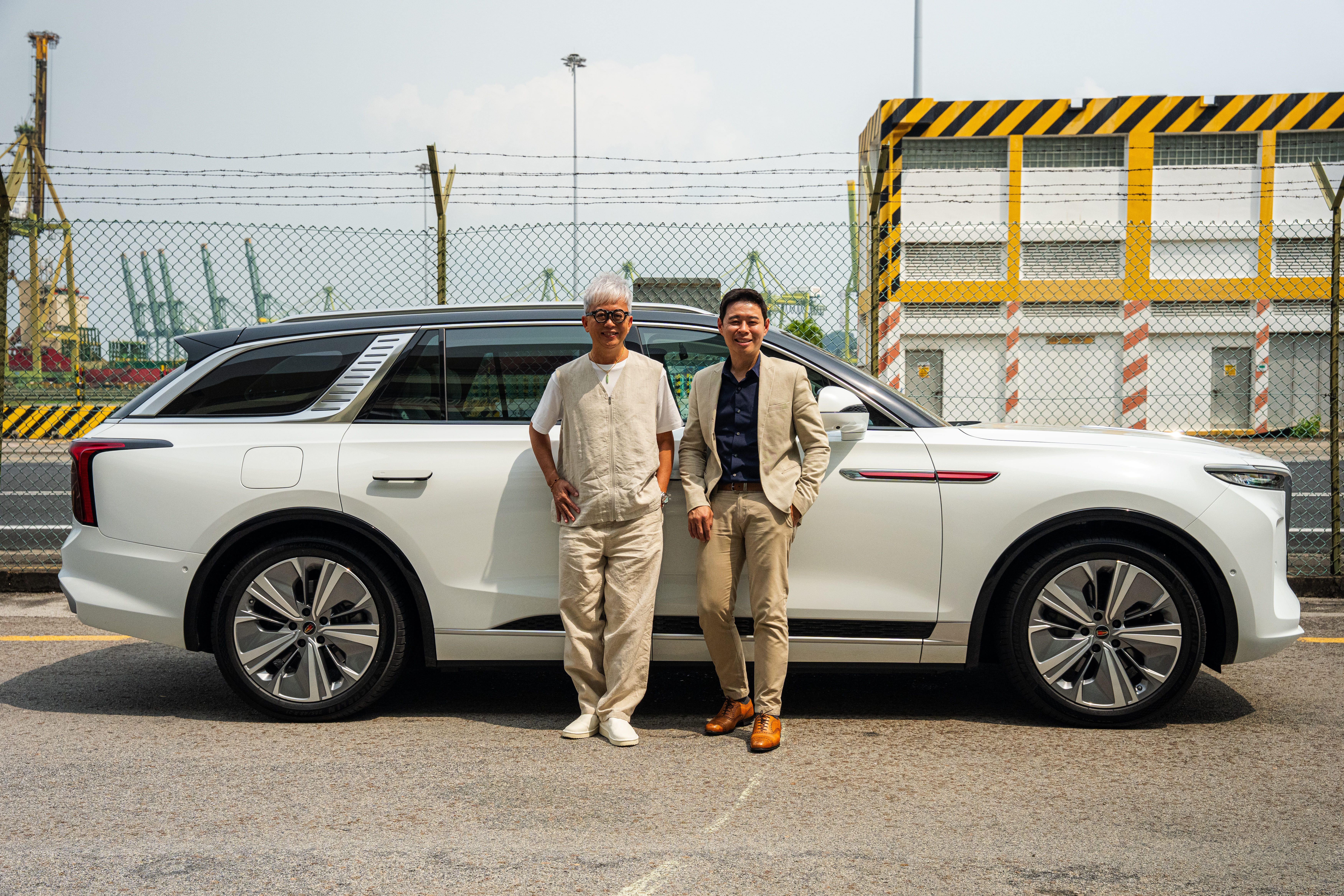 John Cheng, right, with a fellow participant beside a Hongqi E-HS9 during the Beyond 2359 interview feature
