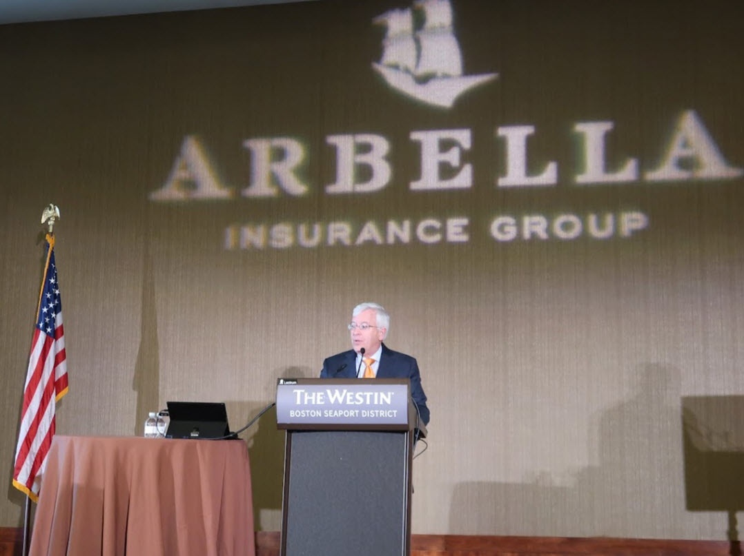 John Donohue speaking at a lectern during Arbella’s luncheon at the 2022 MAIA Big Event