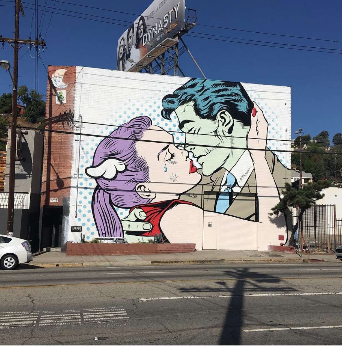 Large comic-style mural covering the exterior of the studio building pictured in Evershed’s merger biography