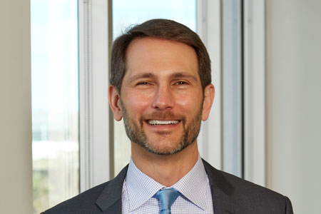 John Fowler smiling in a press photograph