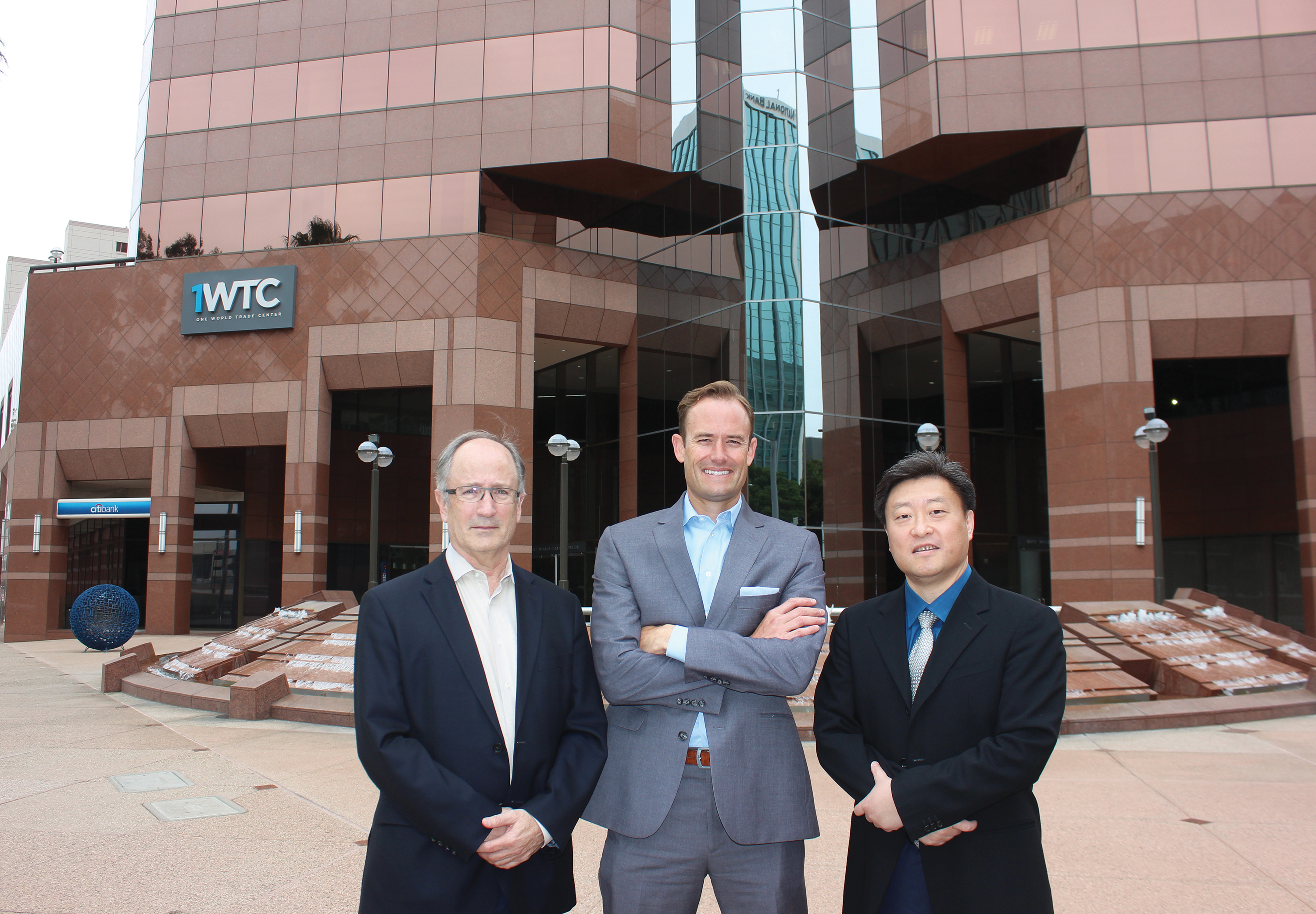 Wade Martin, John Keisler and John Shen standing outside One World Trade Center in Long Beach