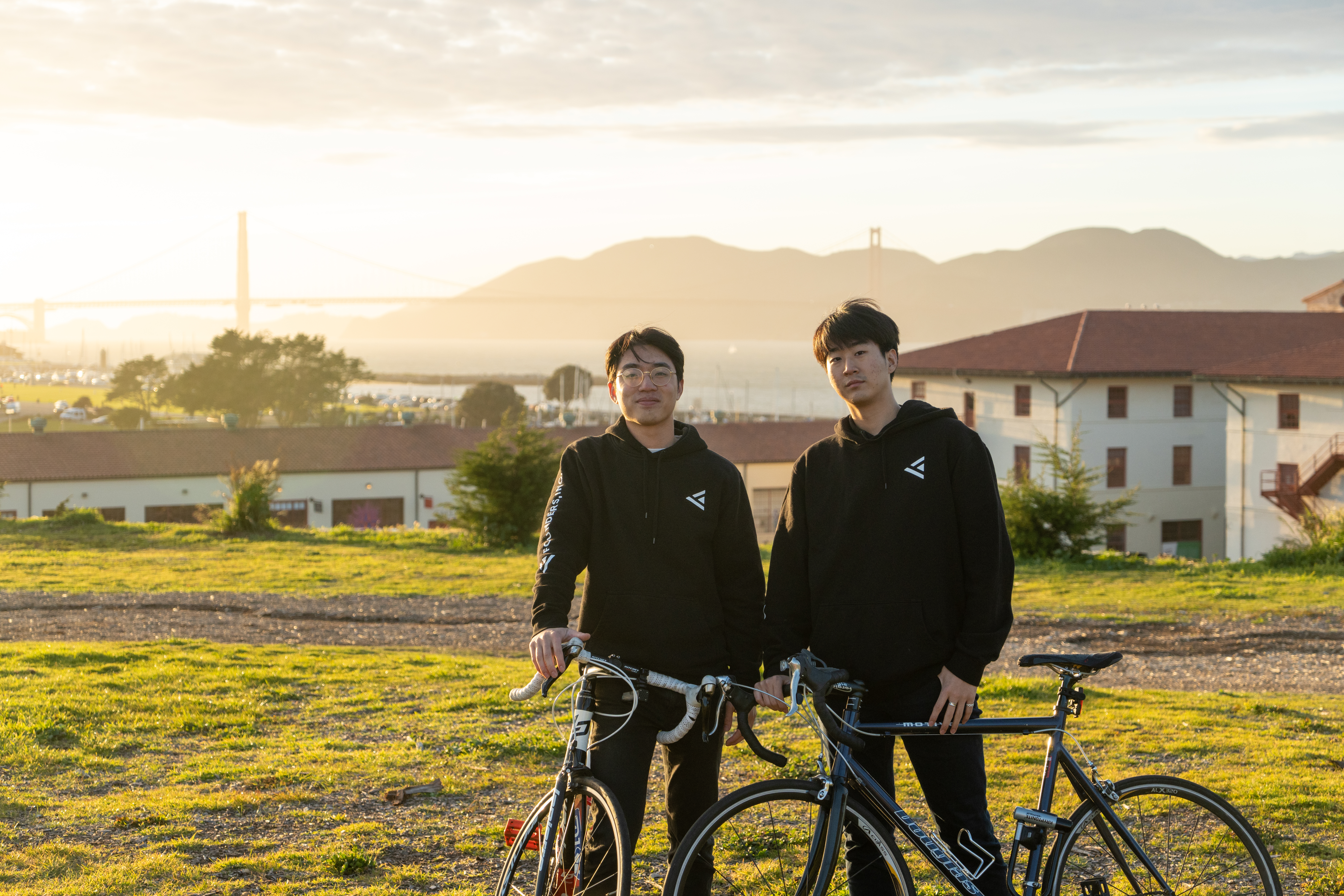 Paraform co-founders Jeffrey Li and John Kim standing with bicycles in San Francisco