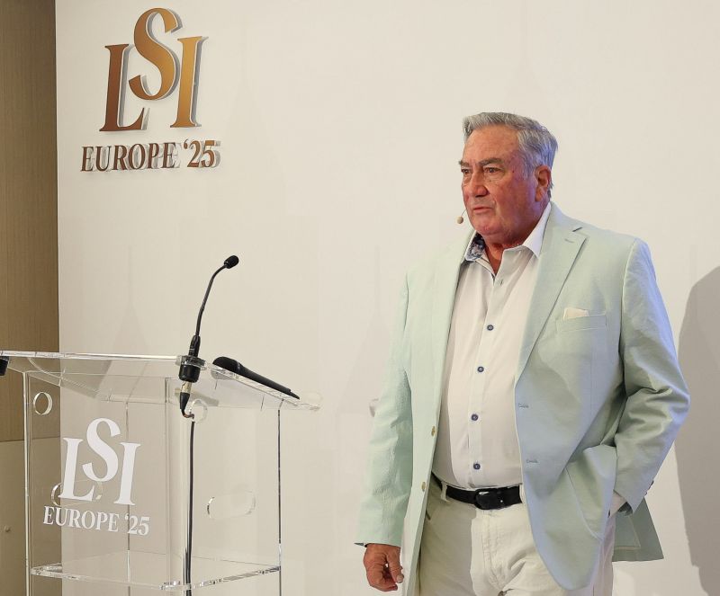 John Martino speaking beside the transparent LSI Europe 2025 lectern