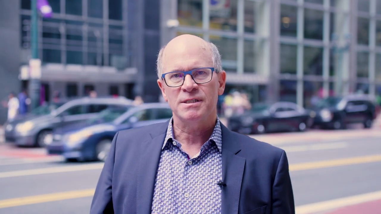 John McLeod speaking on a Philadelphia street during RideCo's 2024 APTAtech video