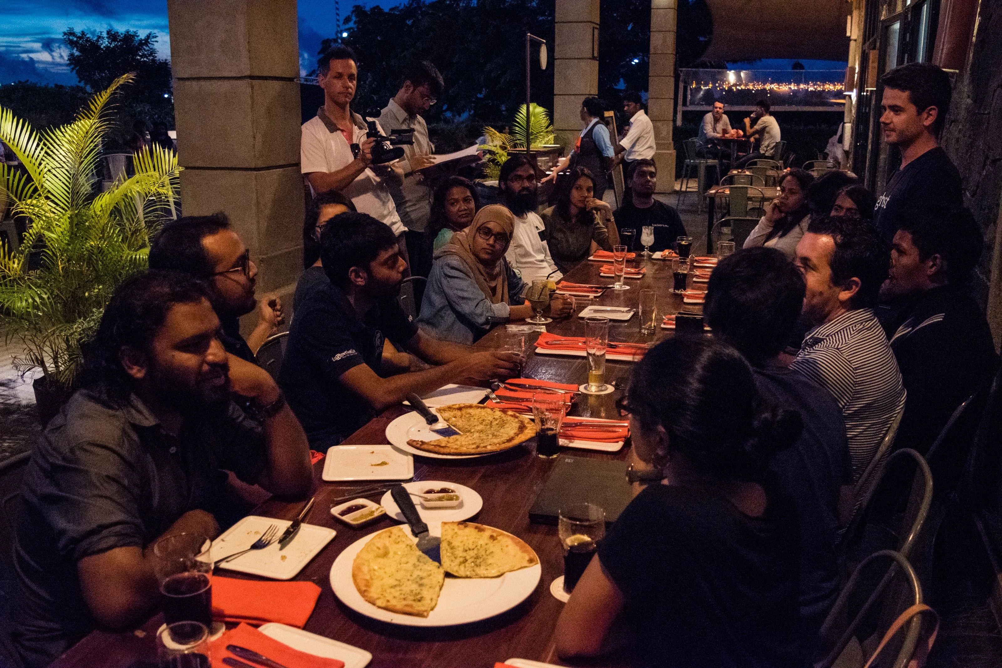 John O’Nolan stands at the right of a long table, speaking with developers at Flying Dodo in Mauritius.