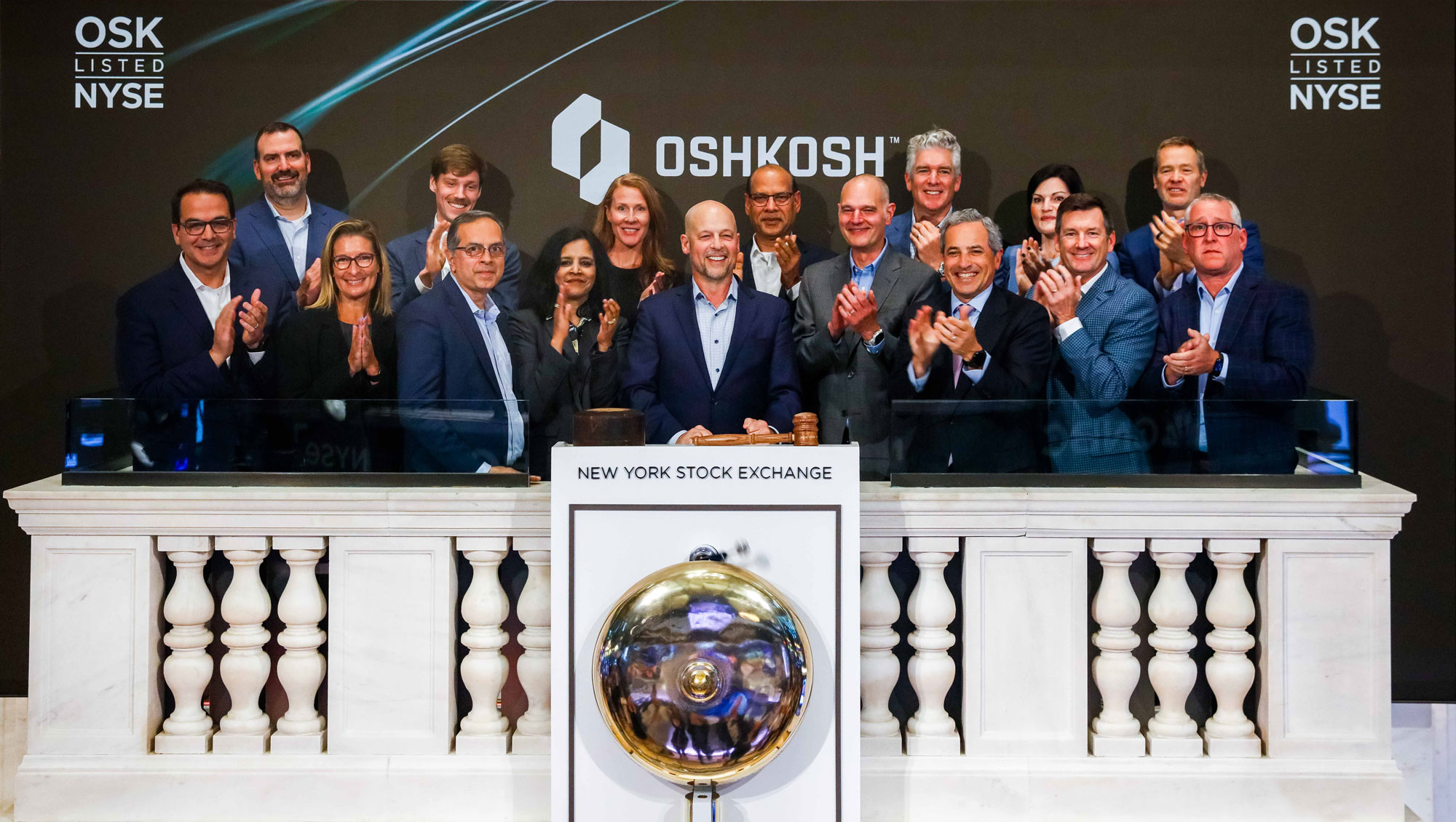 Oshkosh leaders gathered on the New York Stock Exchange closing bell podium in June 2025