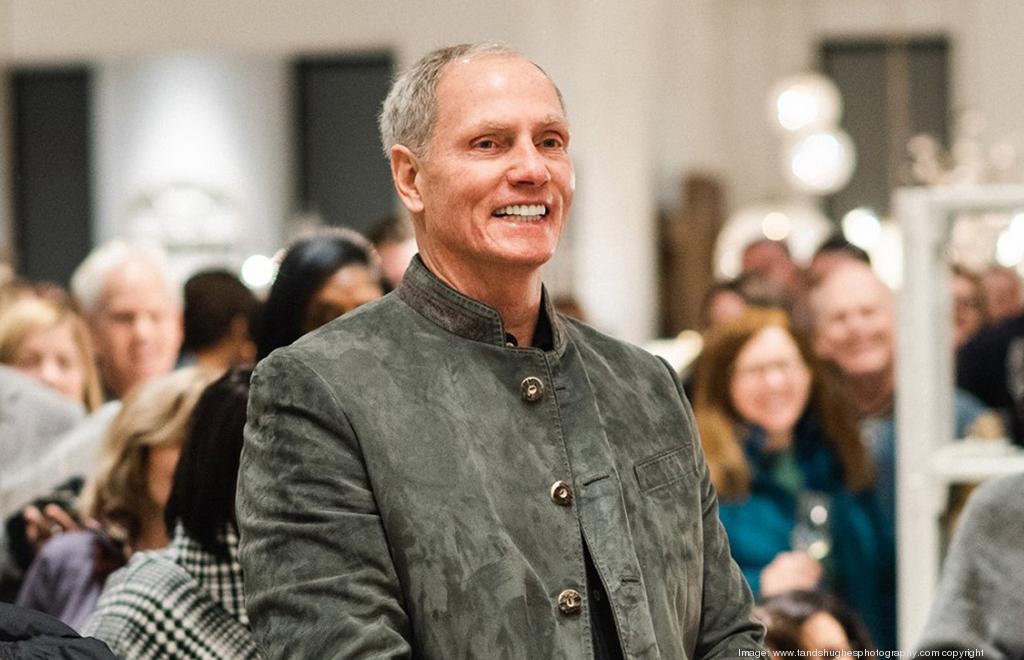 John Reed smiling among a gathering of people