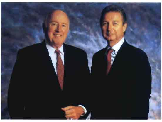 AGCO co-founders Robert Ratliff, left, and John Shumejda, right, wearing suits and ties