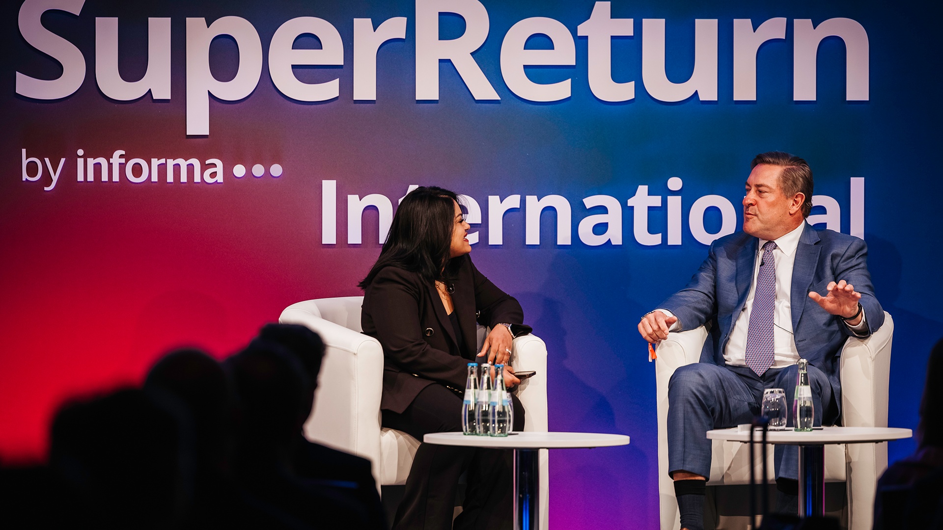John Toomey, seated on the right, in conversation at SuperReturn International.
