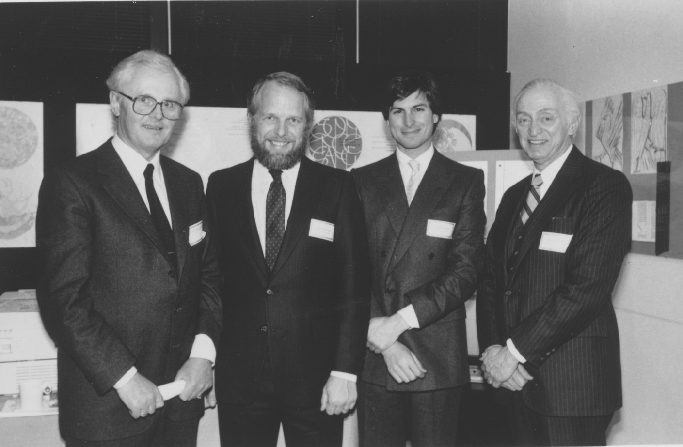 Wolfgang Kummer, John Warnock, Steve Jobs and Aaron Burns standing together at the LaserWriter debut