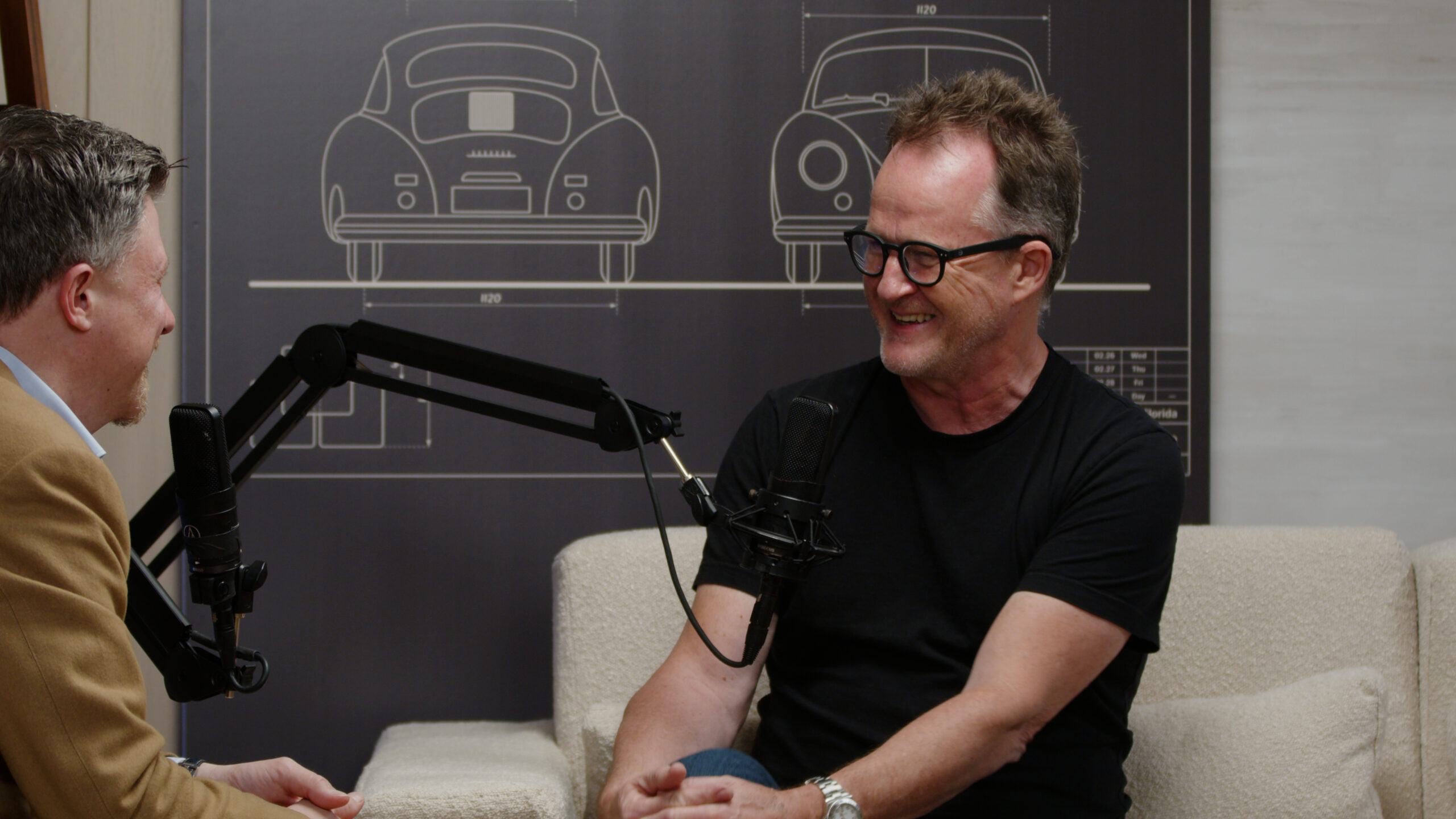 John Wise smiling at a microphone during a seated Innovation Spotlight conversation