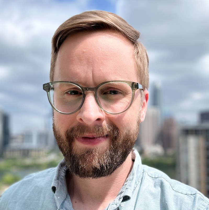 John Yarbrough outdoors in Austin, wearing glasses and a pale blue shirt