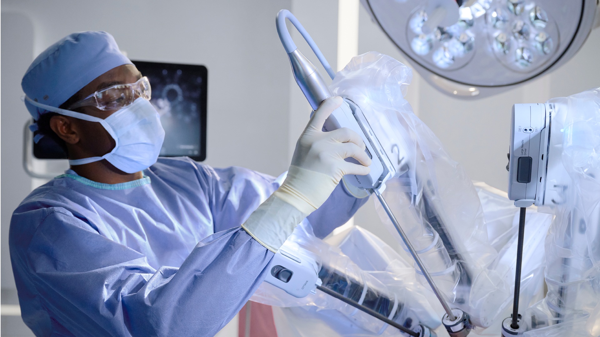 A clinician handles an instrument on Johnson & Johnson’s OTTAVA robotic surgical system