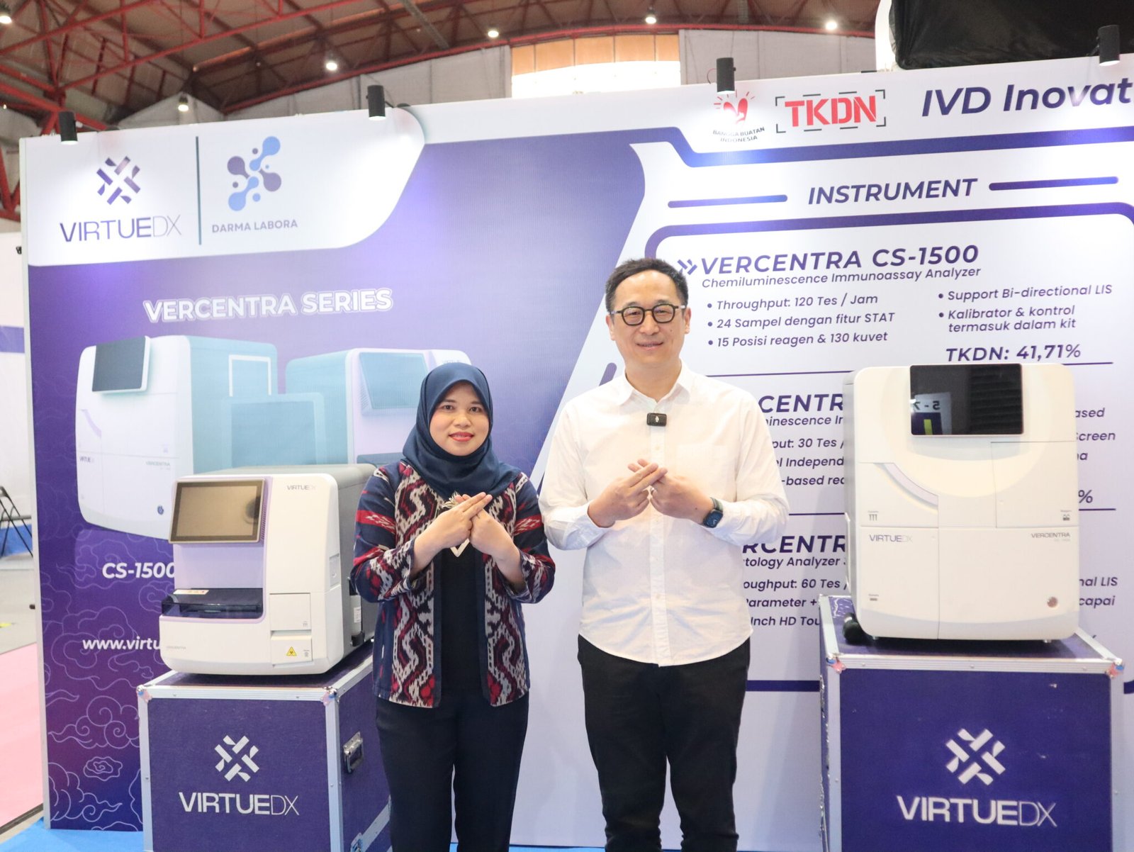 Johnson Zhang and Kurniasari standing at the Virtue Diagnostics exhibition stand in Jakarta