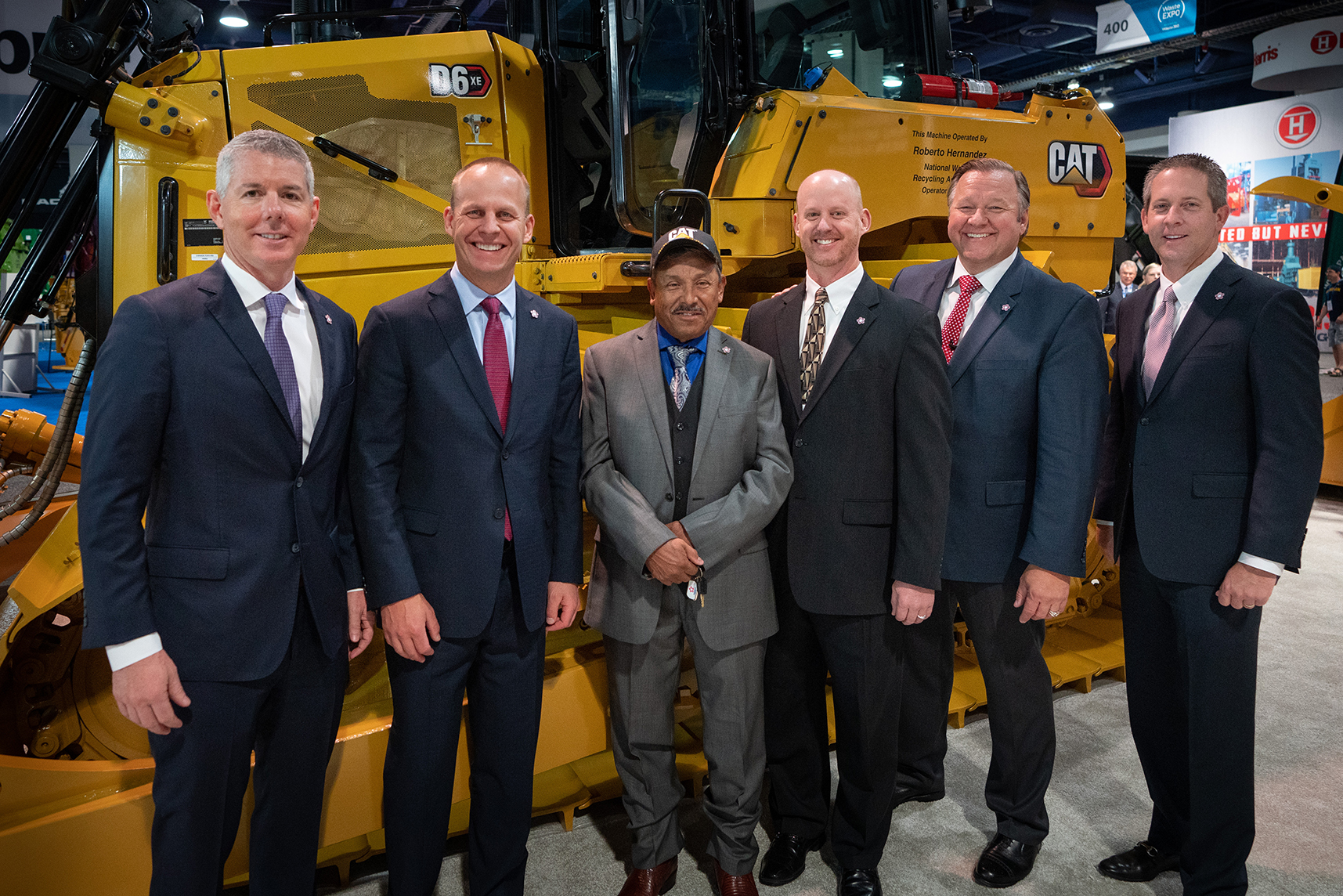 Jon Vander Ark, second from left, stands with Republic colleagues and the 2019 Operator of the Year in front of yellow heavy equipment.