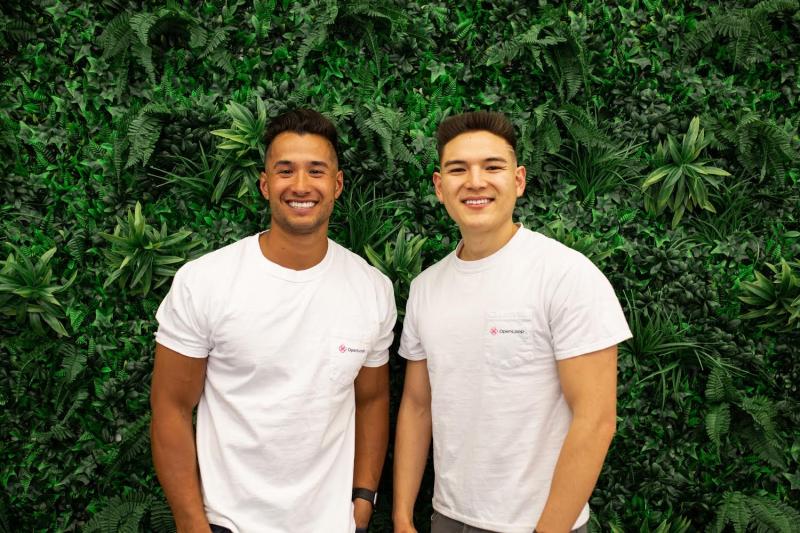OpenLoop co-founders Jon Lensing, left, and Christian Williams, right, standing together in company T-shirts