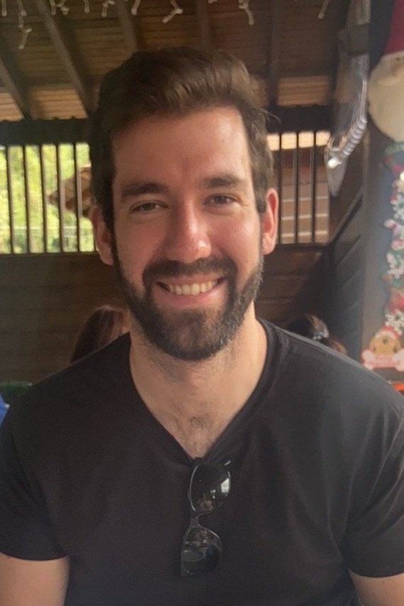 Jon Lorenzini smiling in a casual black shirt