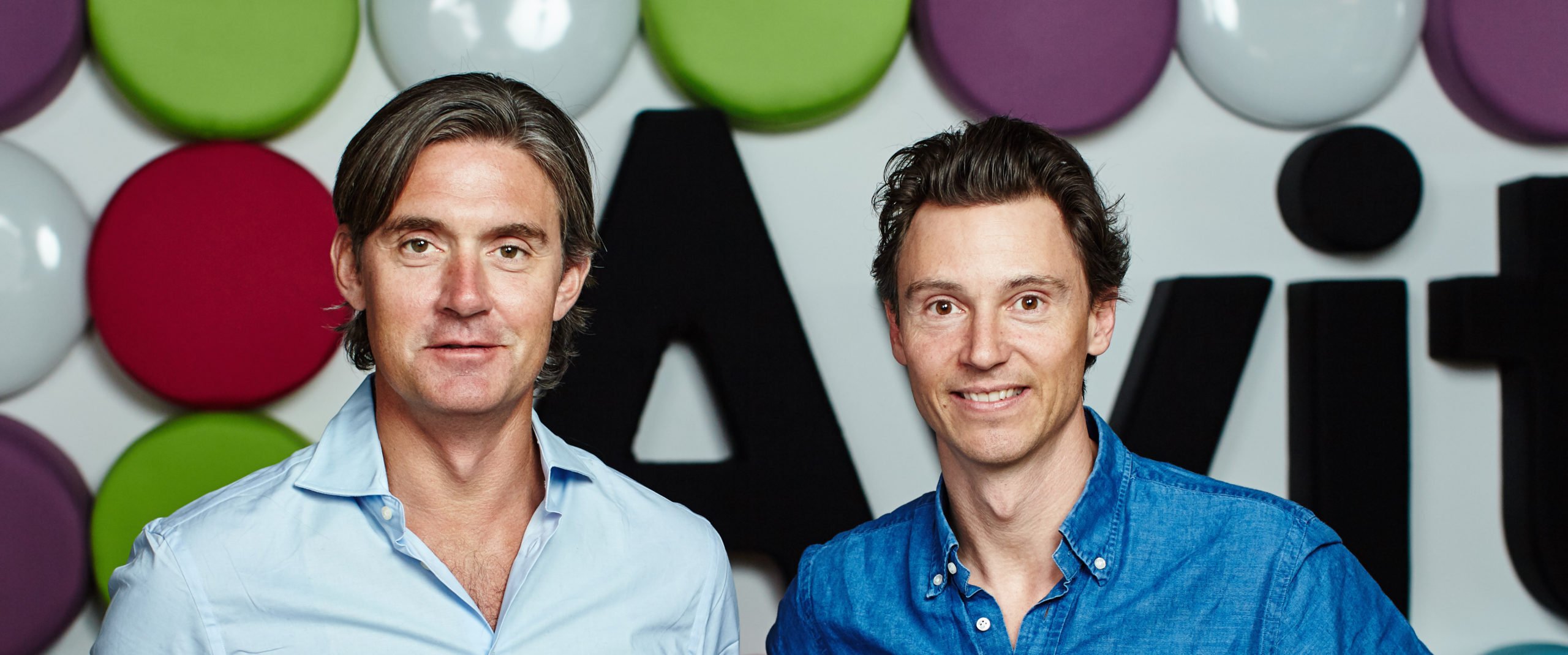 Avito co-founders Filip Engelbert and Jonas Nordlander in front of the company’s colourful wall