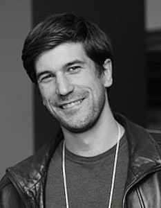A younger Jonathan Asmis in a black and white University of Toronto alumni portrait