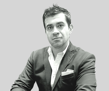 Jonathan Ceja wearing a dark jacket and white shirt in a KUN Capital photograph