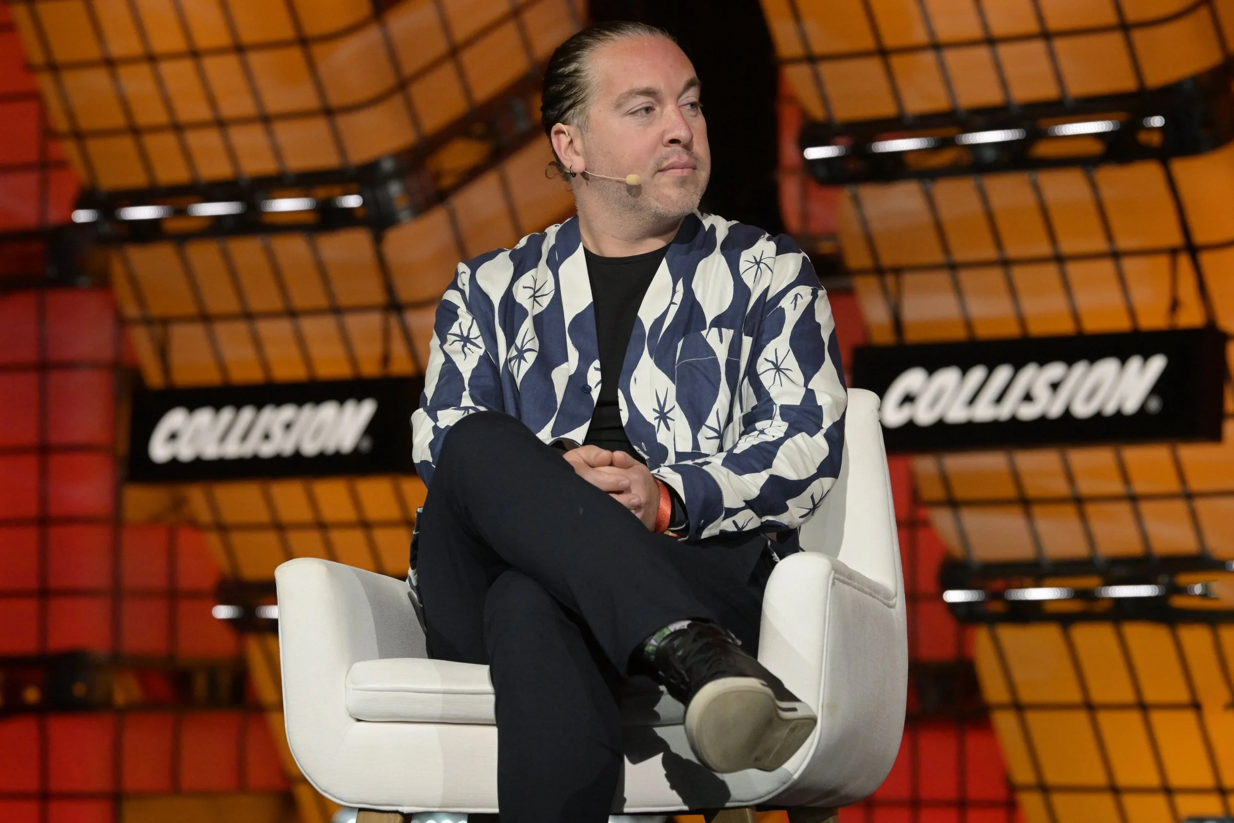 Jonathan Yaffe seated onstage at Collision in 2023