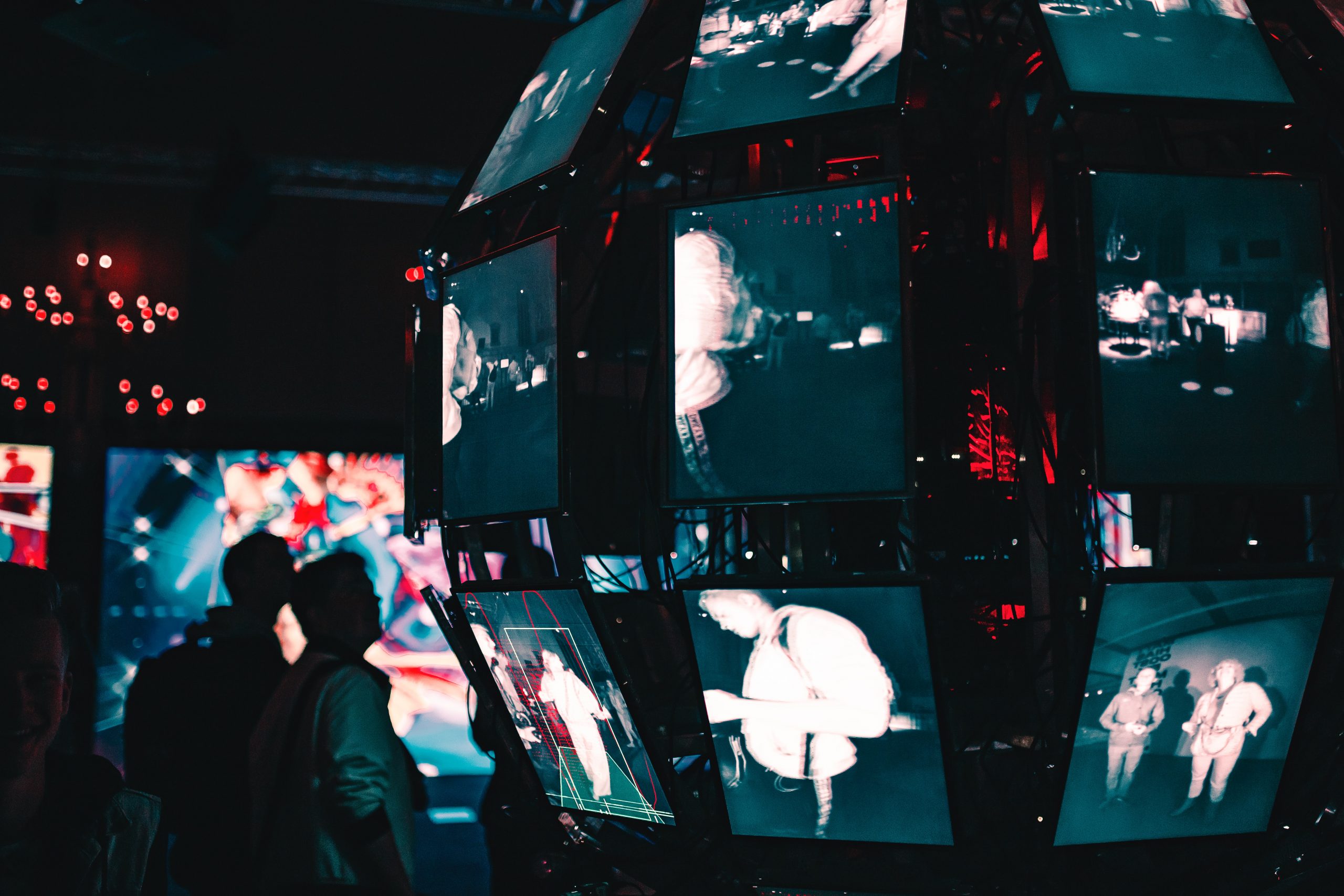 A dark room filled with television monitors showing fragmented images