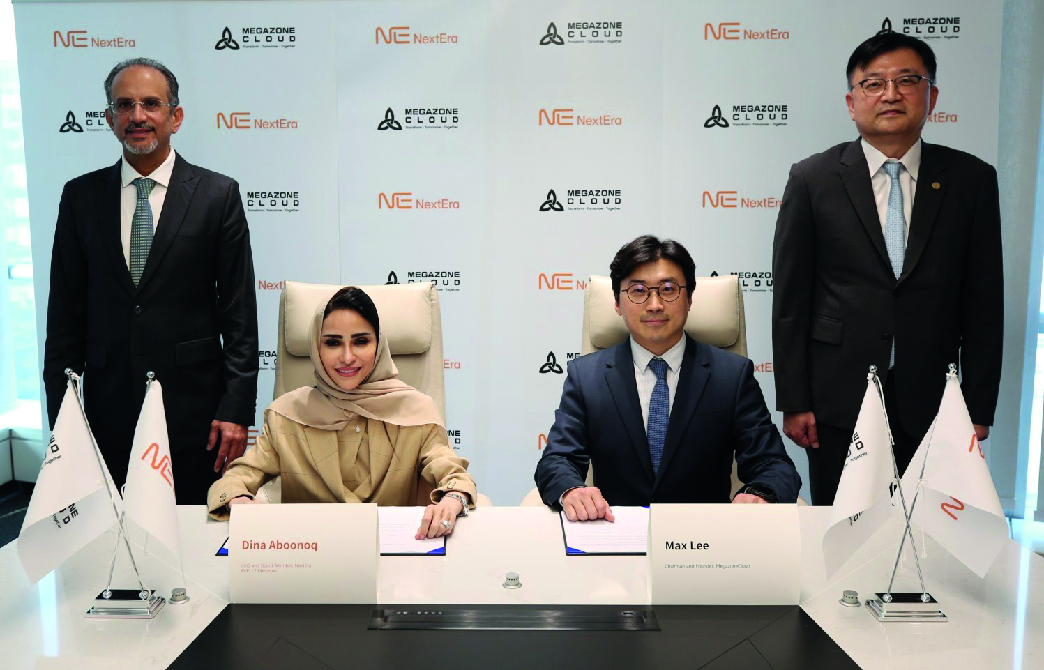 Joo-Wan Lee, seated right, and Dina Aboonoq, seated left, at the NextEra partnership signing