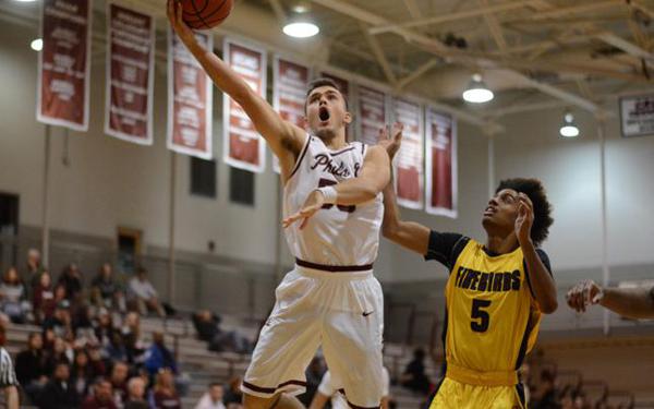 Jordan DeCicco drives toward the basket in a Philadelphia University basketball game