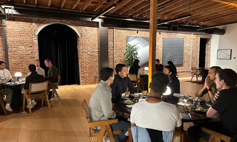 Founders talking around dinner tables at a Turnstile and First Round gathering