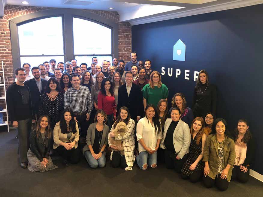 Super staff gathered for a team photograph in their office