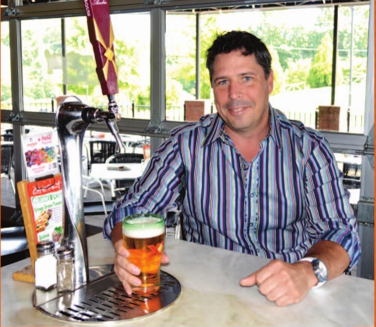 Jose Hevia seated at the original beer table at Cheeky in Suwanee