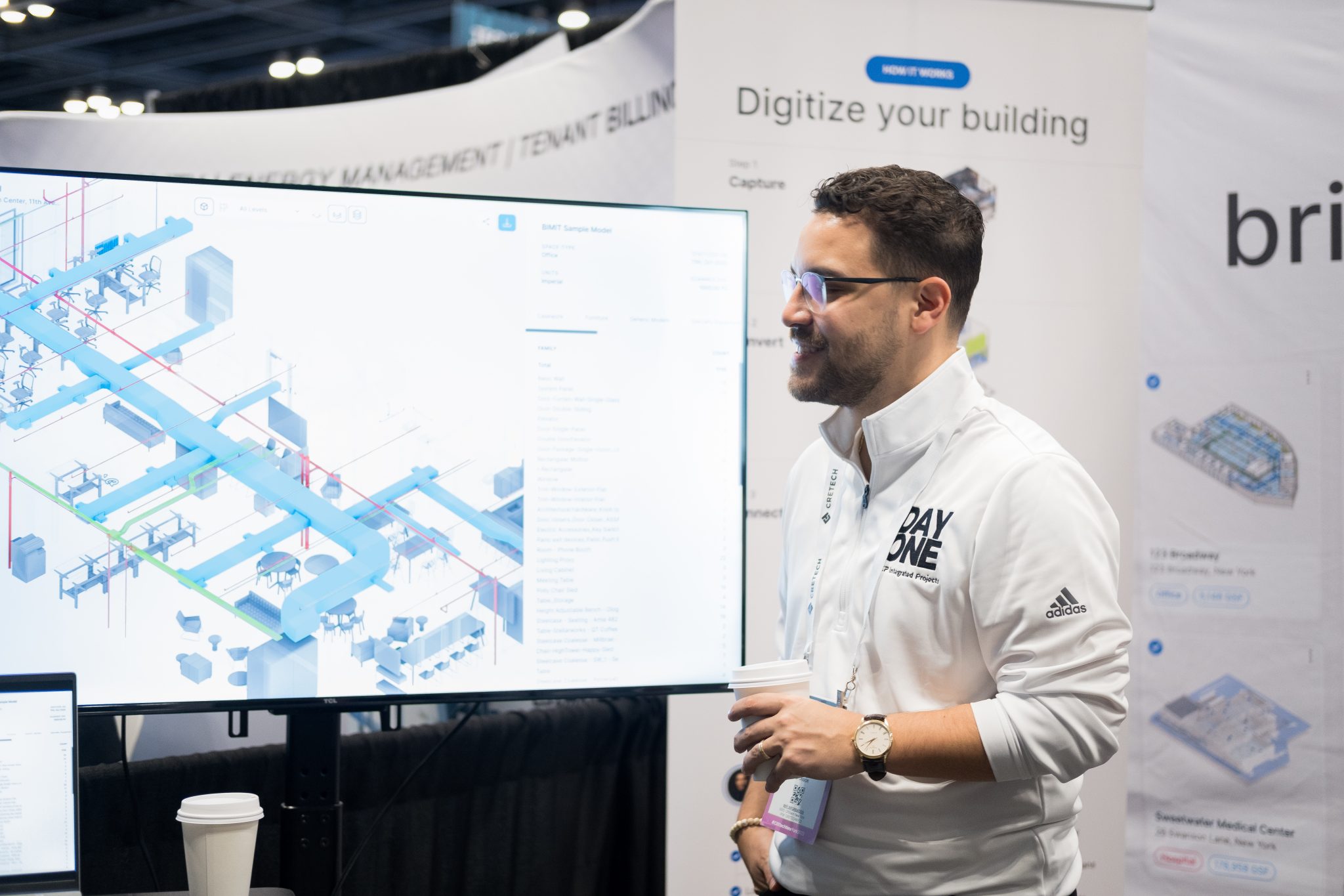 Jose Cruz beside a screen showing a detailed building model