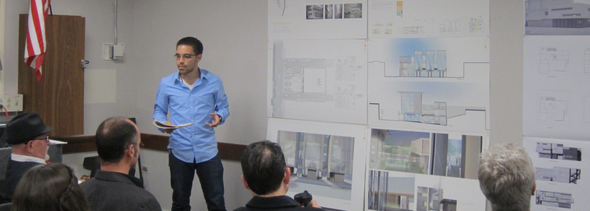 Architecture plans being presented to a seated audience