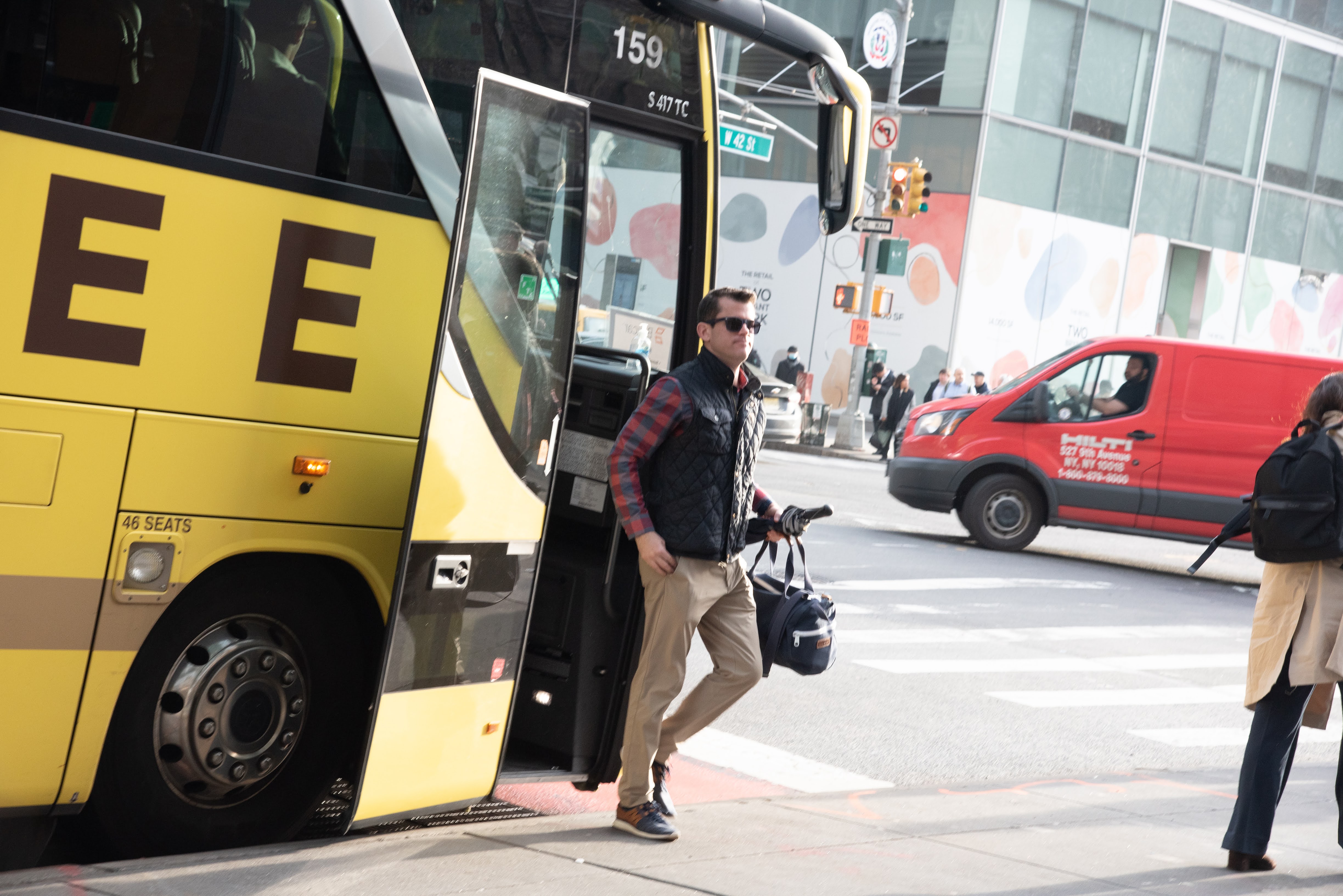 Joseph Colangelo stepping off a yellow coach on Manhattan's 42nd Street