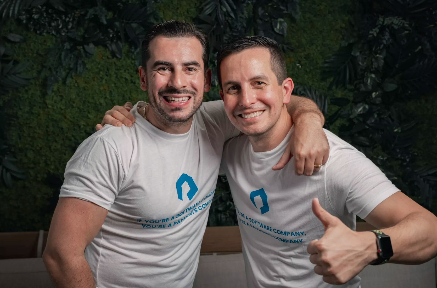 Joseph Elias Phillips, left, and William Corbera smiling together in Payabli shirts