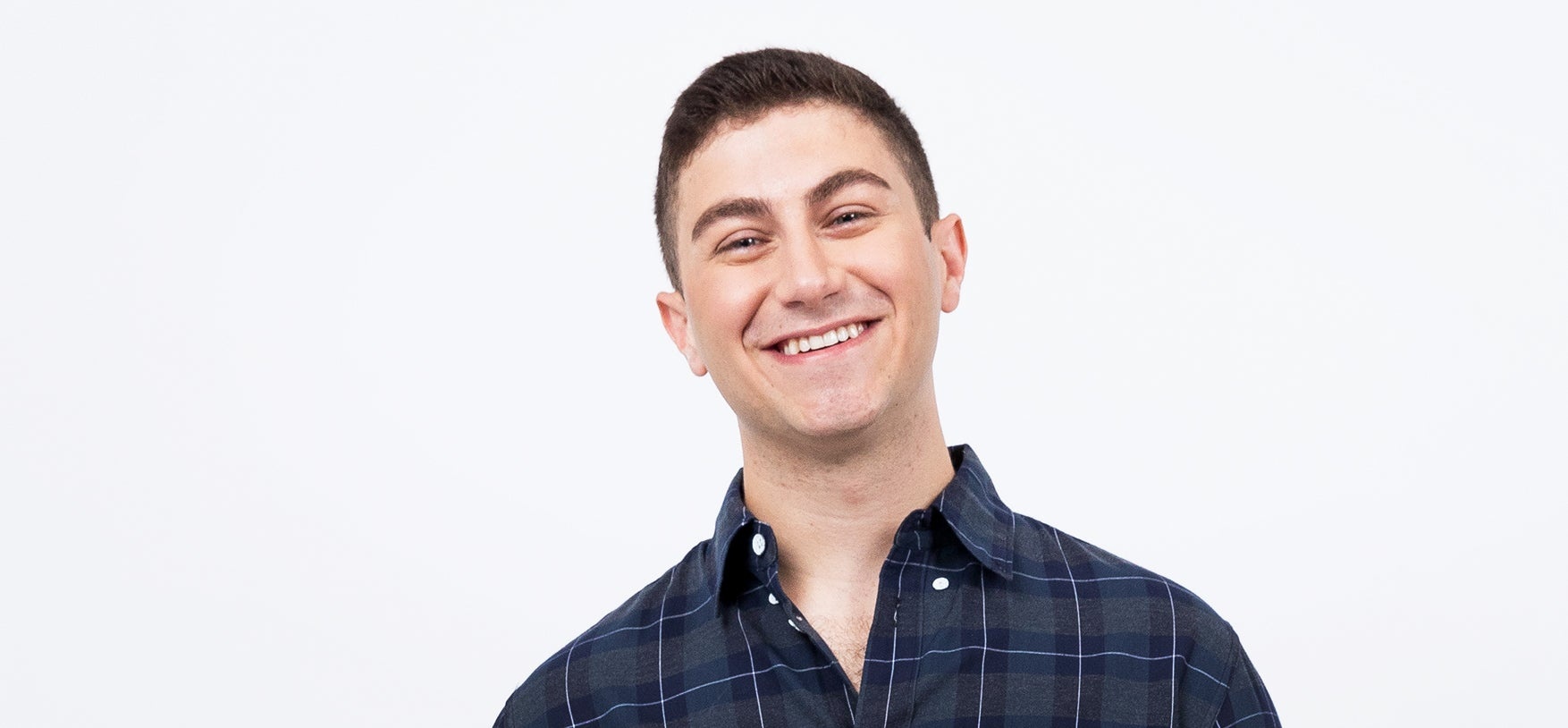 Joseph Fasone smiling in a blue checked shirt