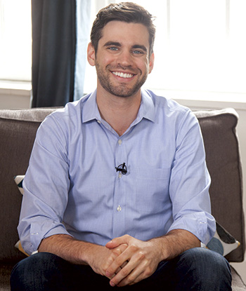 Josh Bruno seated on a sofa in an archival Hometeam photograph