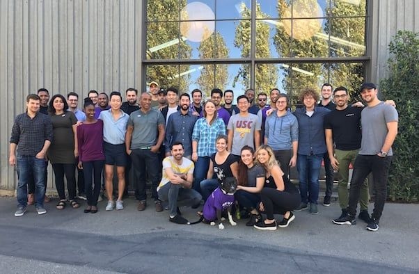 The Skurt team gathered outside an office building, with Josh Mangel in the back row toward the right