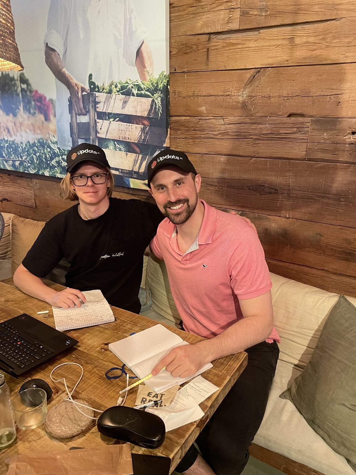Sergey Kondratiuk, left, and Josh Schachter, right, with notebooks at a table in Porto