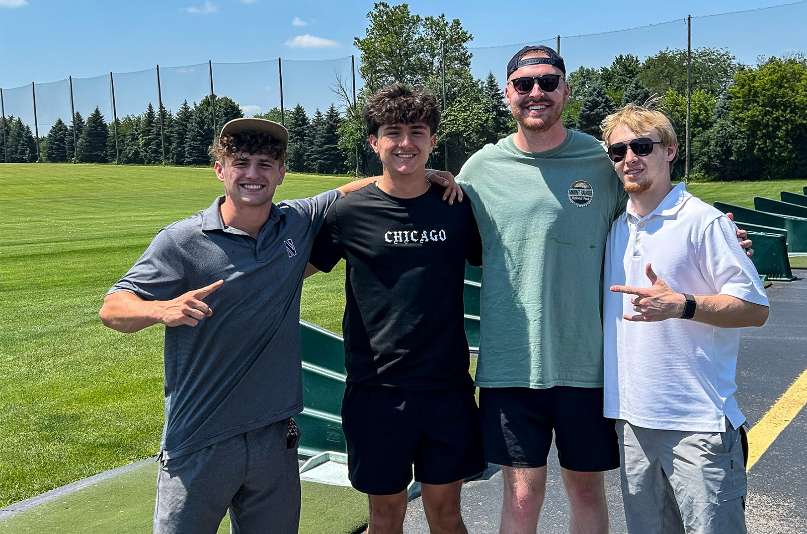 Normal colleagues at a golf driving range in 2024: Justin Benjamin, John Reyes, Joshua Blew and Jake Penzato