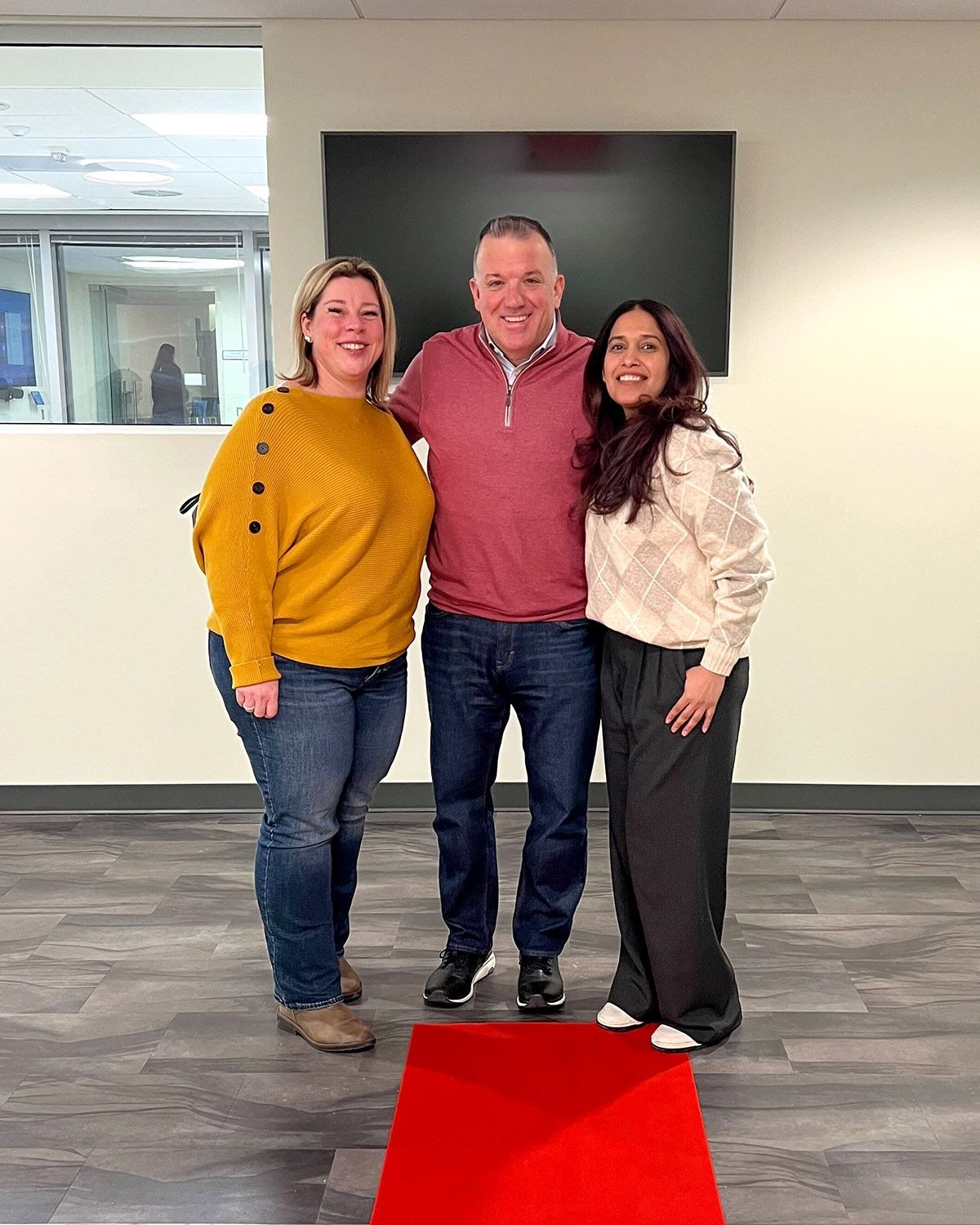 Three colleagues posing together at IntegriChain’s Philadelphia office grand opening