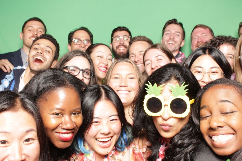 Joshua Schnoll with members of the Everlaw team in a crowded, playful group photograph