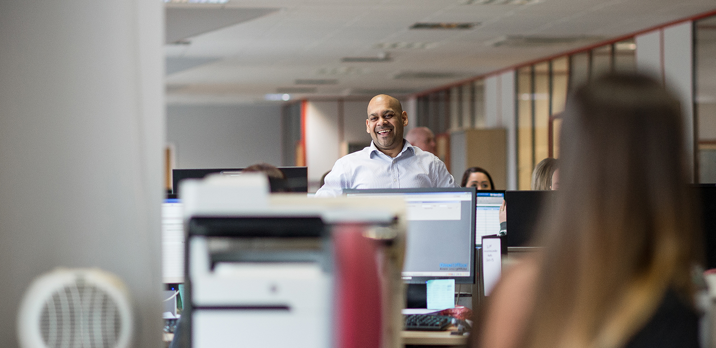 Members of the Journeo team working in an open-plan office