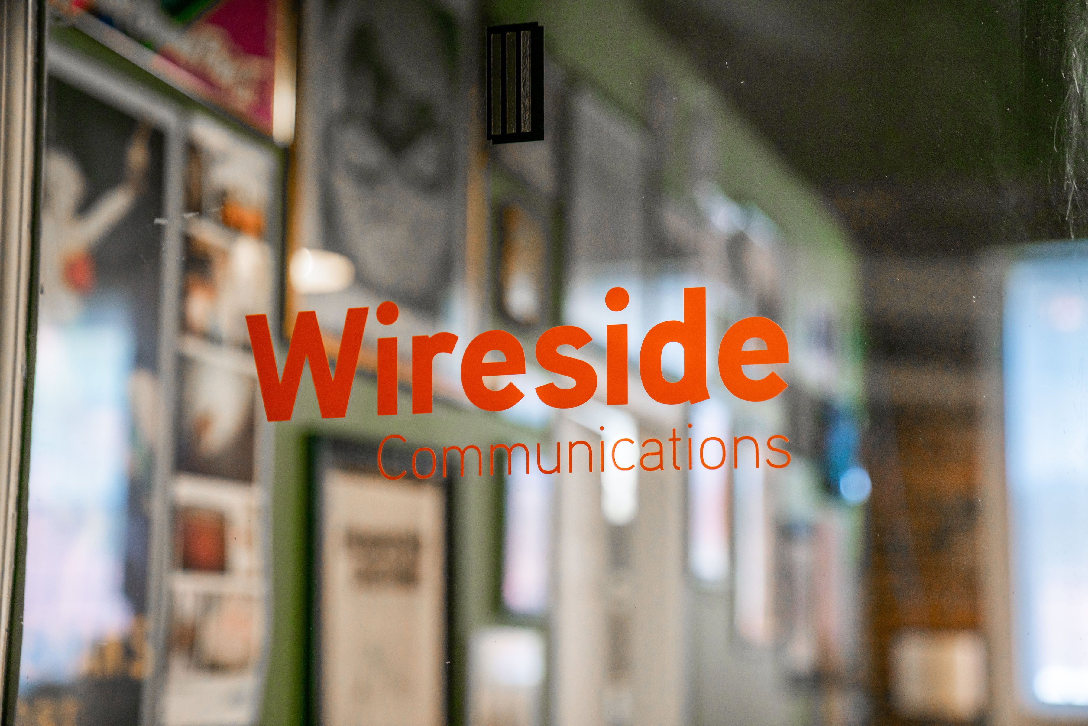 Wireside Communications lettering on a glass door
