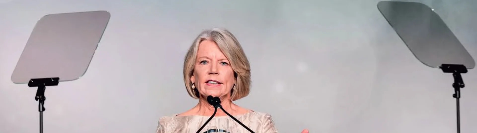 Joyce Durst speaking between teleprompters at the EY Entrepreneur Of The Year award ceremony
