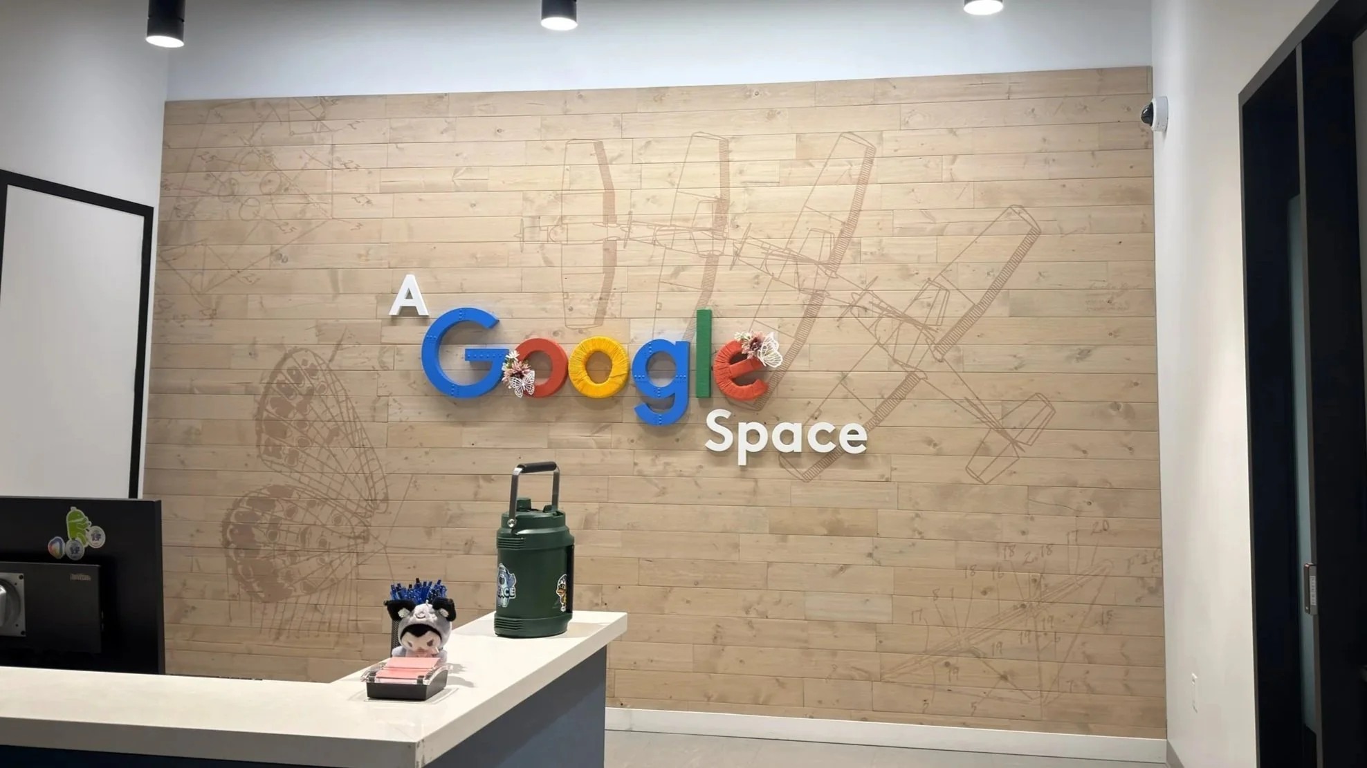 Dimensional Google logo and environmental graphics installed on a wood feature wall