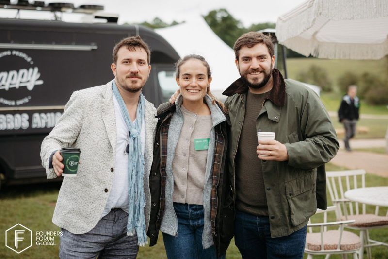 Juan Pablo Ortega, right, with two attendees at Founders Forum Global outdoors