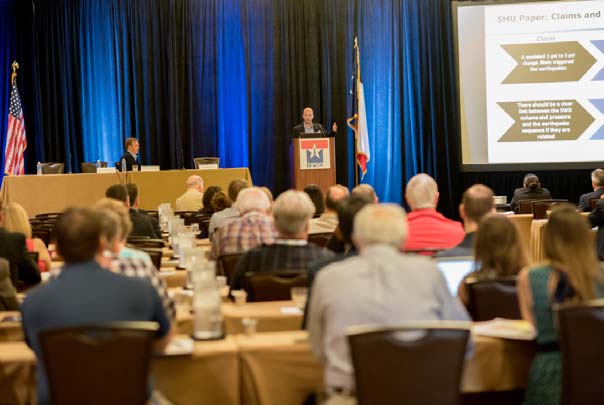 An audience listens to Jud Walker delivering a keynote at the 2015 TIPRO summer meeting