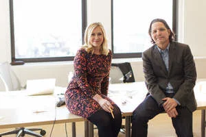 Judith Carr-Rodriguez seated beside Mark Figliulo in an agency office