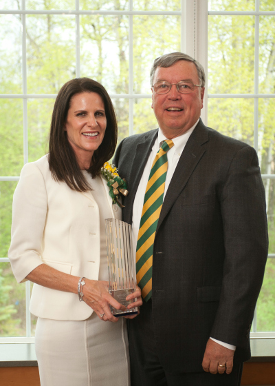 Judy Capano holding Siena's 2016 Entrepreneur of the Year award beside David Stack